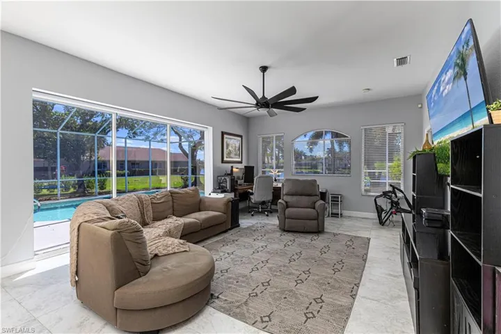 Family room w/ access to pool & view of lake