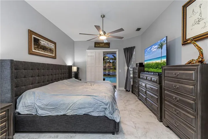 Primary Bedroom featuring access to exterior and ceiling fan
