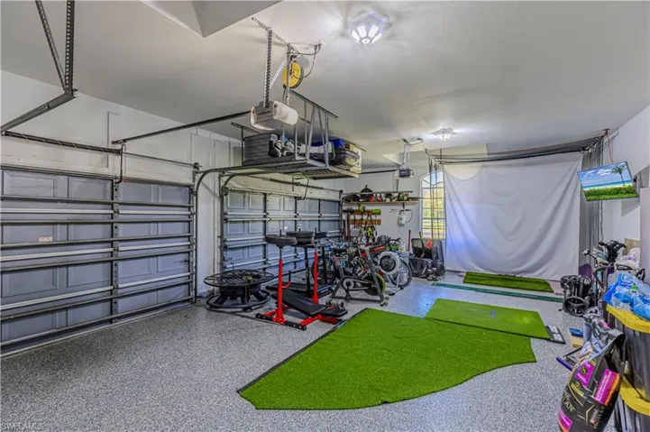 Spacious 3 car Garage with a garage door opener & custom flooring
