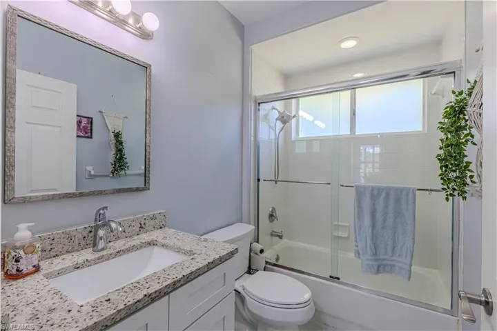 Guest Bathroom w/ vanity, shower / bath combination glass door & recessed lighting