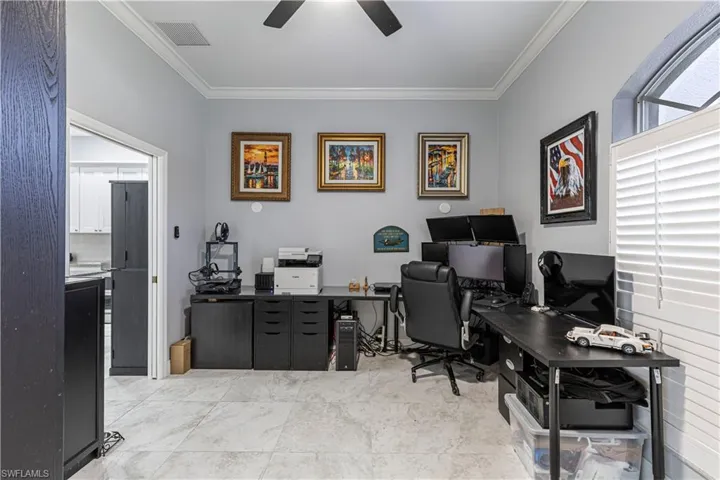 Office/Den with crown molding and a ceiling fan