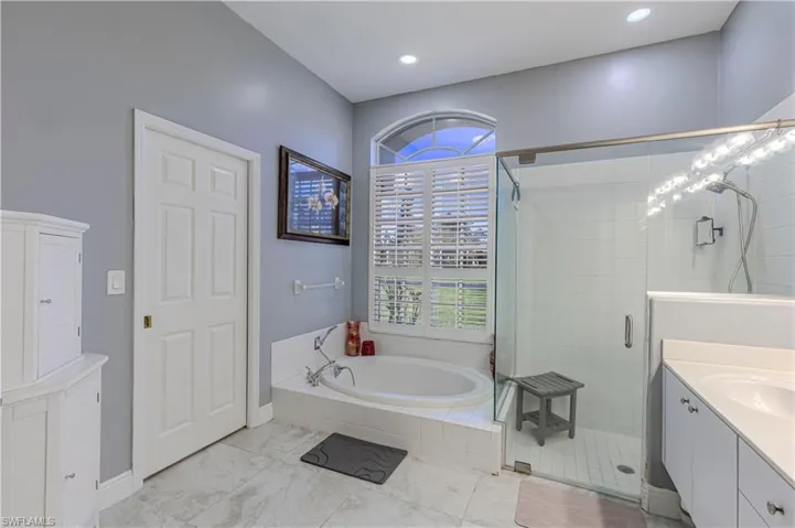 Primary Bathroom w/ double vanity, shower stall & bathtub