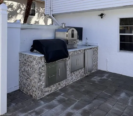 View of patio / terrace with exterior kitchen, grilling area, and a sink
