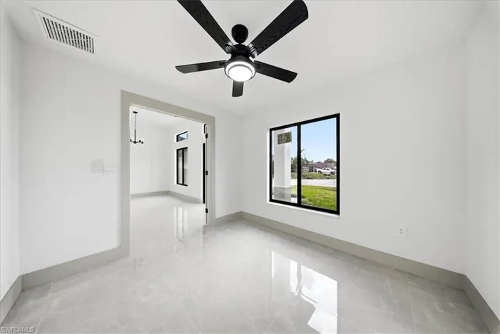 Spare room with baseboards and ceiling fan