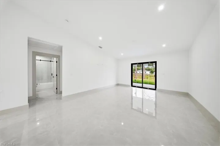 Empty room with baseboards and recessed lighting
