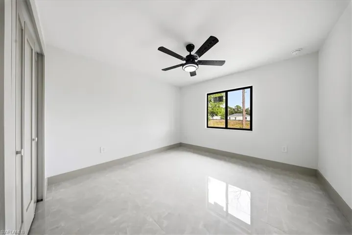 Unfurnished room featuring baseboards and a ceiling fan