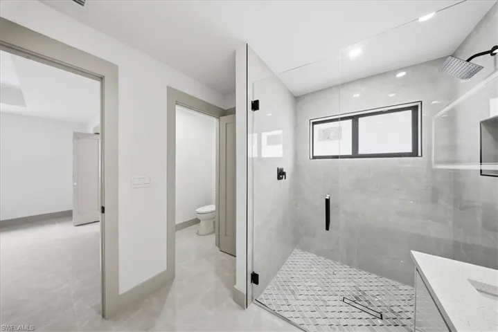 Full bathroom featuring a stall shower and vanity