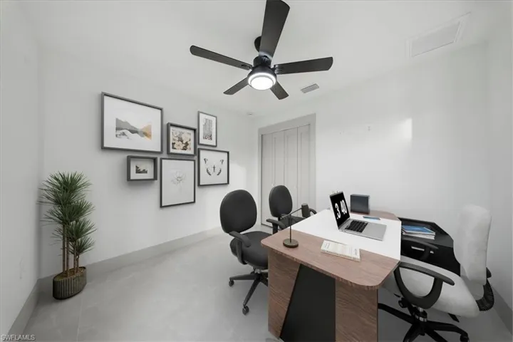 Office space featuring a ceiling fan and concrete flooring