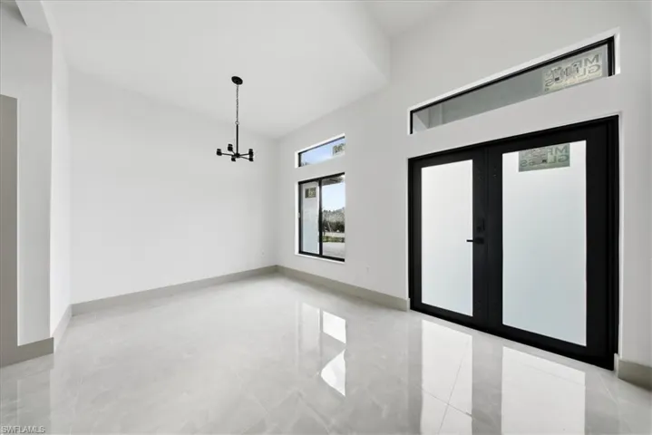 Foyer entrance featuring a high ceiling and french doors