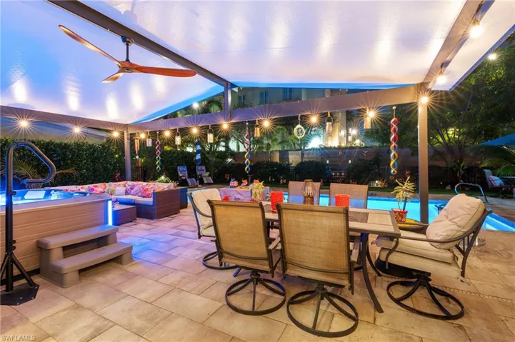 View of patio / terrace featuring a hot tub, an outdoor hangout area, and ceiling fan