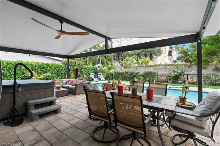 View of patio / terrace with outdoor lounge area, ceiling fan, and a pool with hot tub