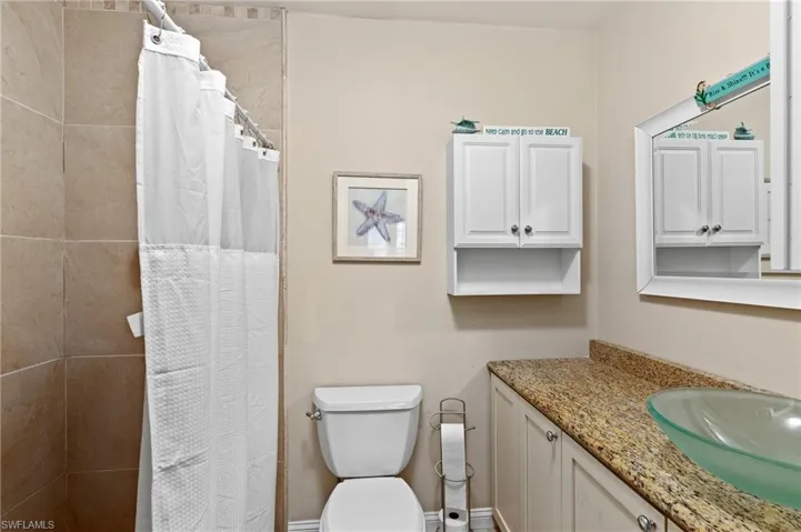 Bathroom with vanity, toilet, and walk in shower