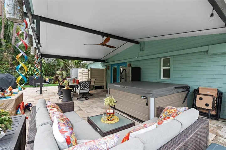 View of patio / terrace with a hot tub, area for grilling, an outdoor hangout area, and ceiling fan