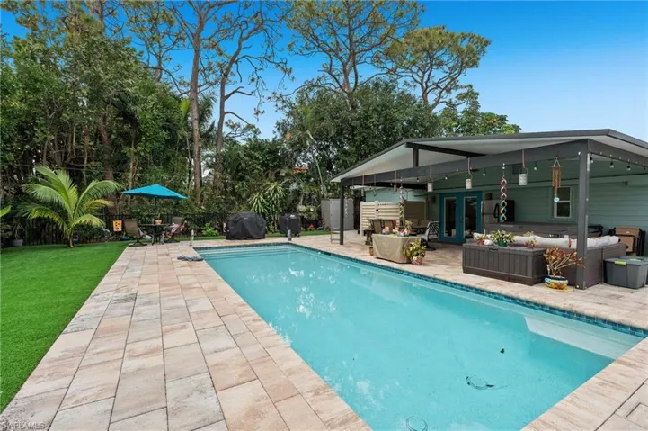 View of pool featuring a grill, outdoor lounge area, and a patio