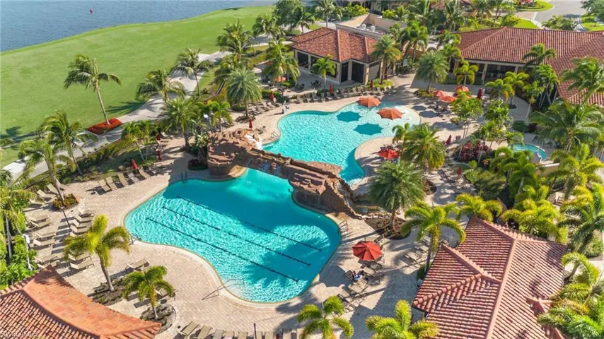 View of swimming pool with a water view and a patio area