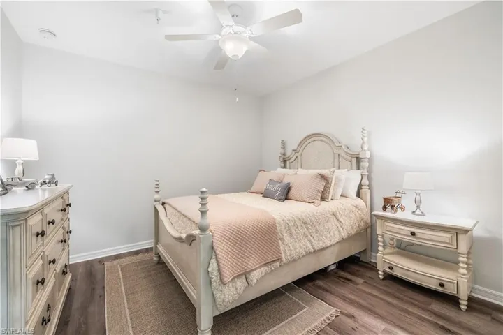 Bedroom with ceiling fan and hardwood / wood-style flooring