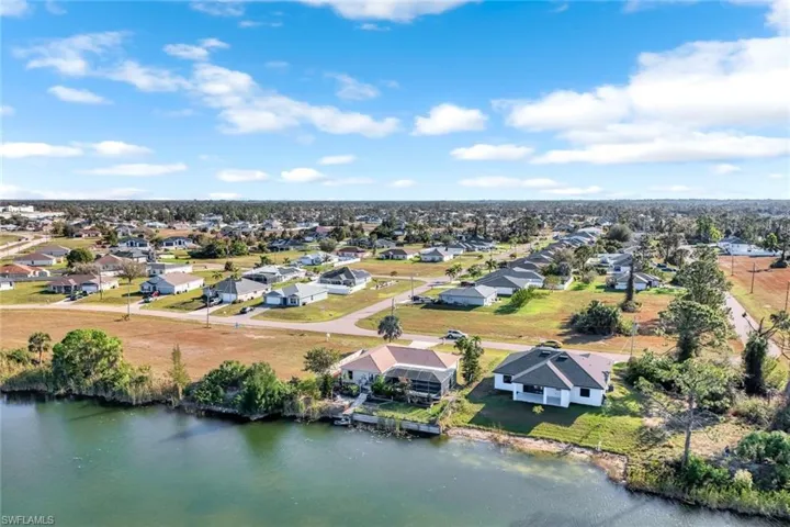 Birds eye view of property with a residential view and a water view