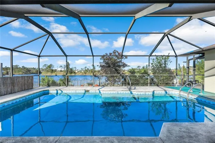 View of pool featuring a lanai, a fenced in pool, and a patio
