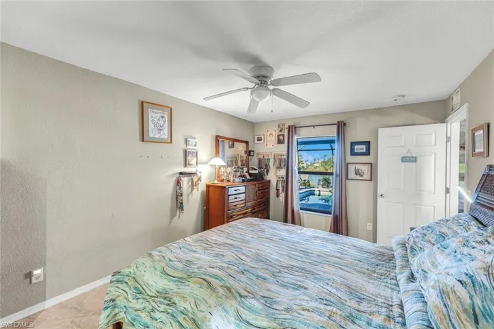 Bedroom featuring visible vents, light tile patterned floors, a closet, and a ceiling fan