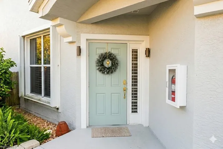 Entrance to property featuring stucco siding
