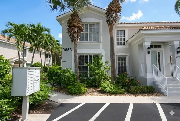 View of front facade with stucco siding and a tiled roof