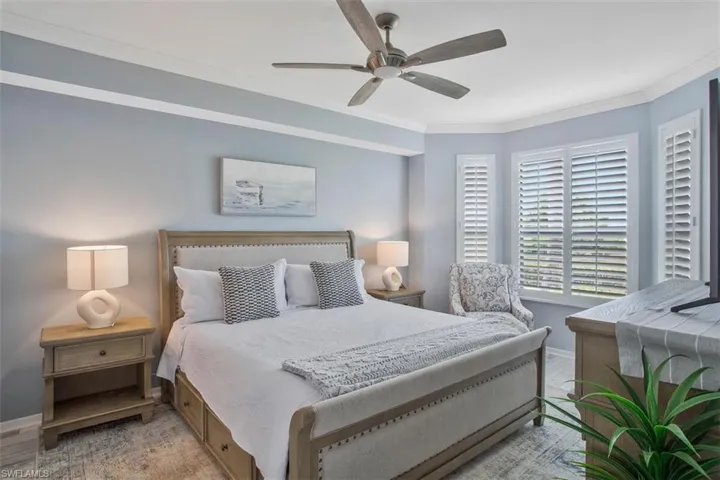 Bedroom featuring ceiling fan and ornamental molding