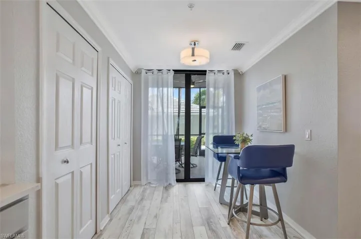Dining space featuring light hardwood / wood-style floors, french doors, and crown molding