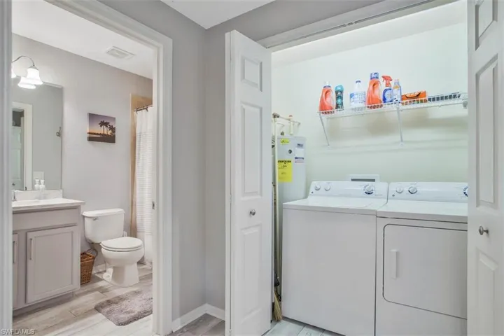 Full washer and dryer in hallway for easy access.