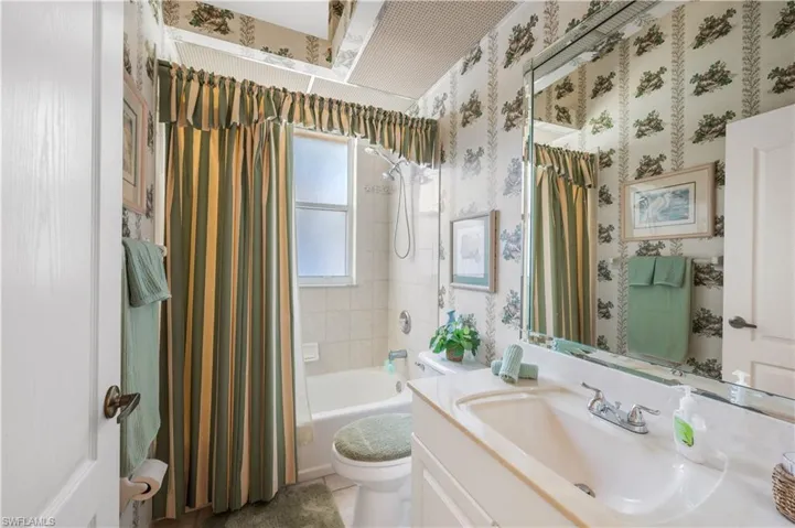Full bathroom with shower / tub combo, vanity, and toilet