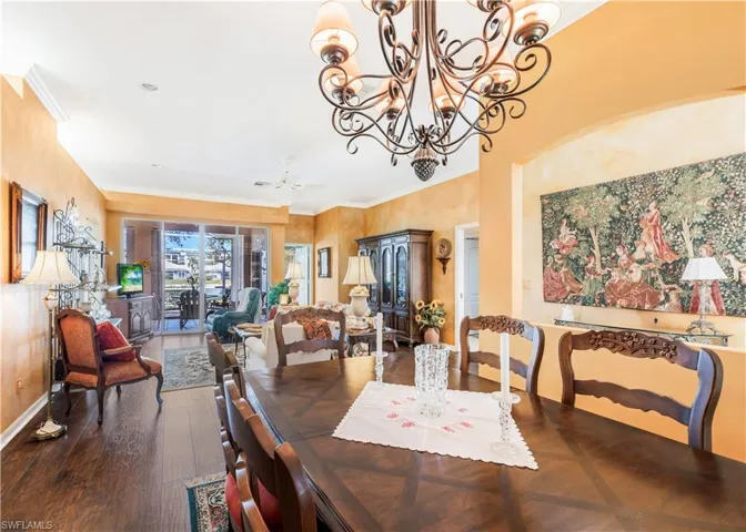 Dining room featuring wood-type flooring, ornamental molding, and ceiling fan