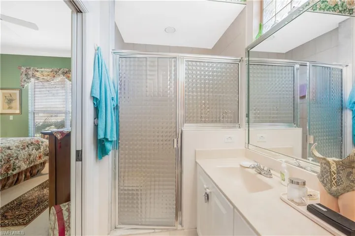 Bathroom with vanity and a shower with door