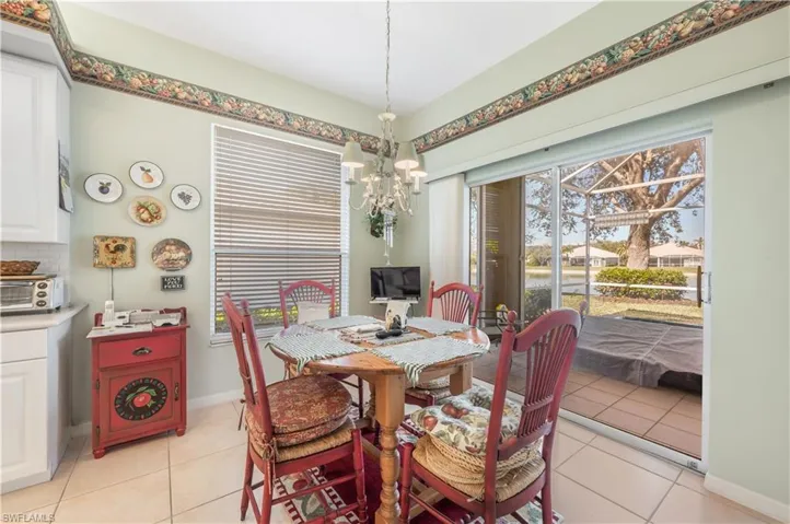 Tiled dining area featuring a notable chandelier
