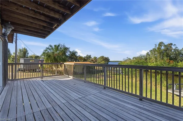 Wooden deck featuring a lawn