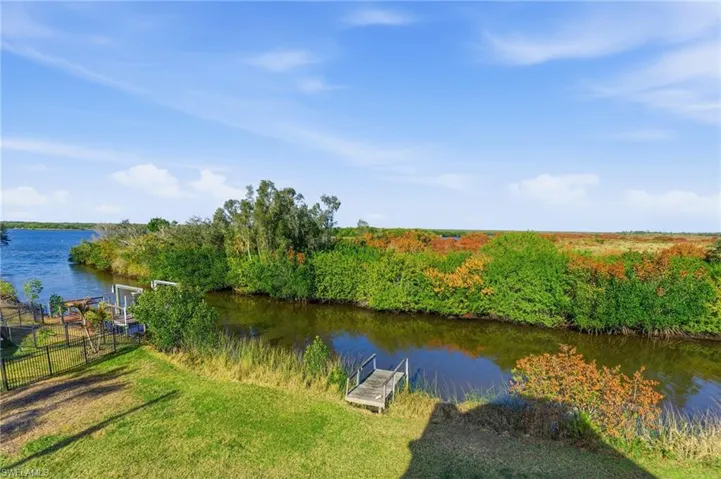 Dock with a water view and a lawn