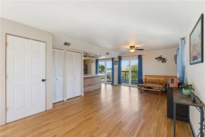 Sitting room with light wood-type flooring and ceiling fan