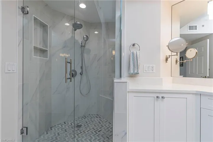Full bath featuring a stall shower and vanity