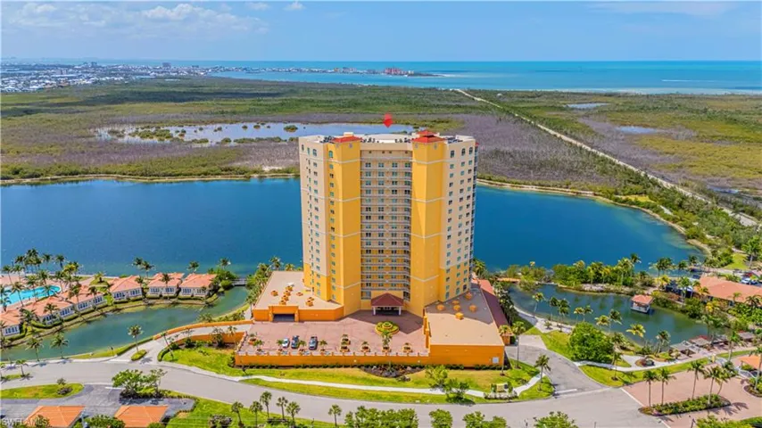 Bird's eye view of a nearby body of water and apartment complex / building