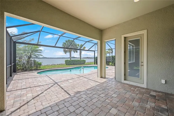 Outdoor pool with glass enclosure and a water view