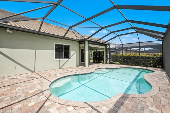 Pool featuring a lanai and a patio area