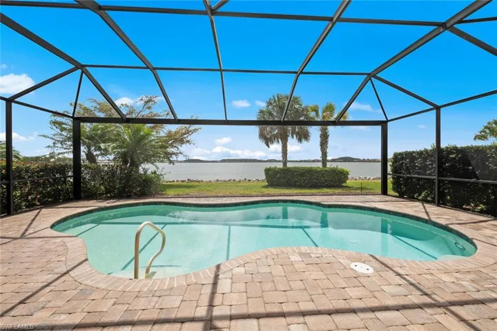 Outdoor pool with glass enclosure and a water view