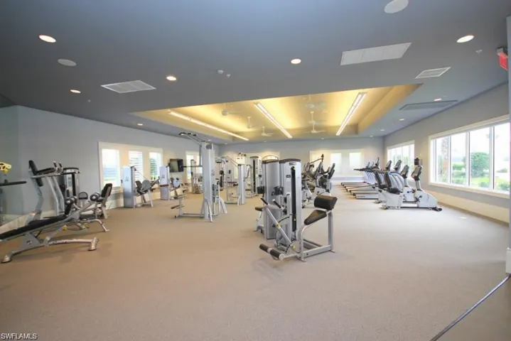 Exercise room featuring plenty of natural light, recessed lighting, and visible vents