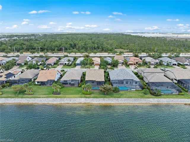 Drone / aerial view with a water view and a residential view