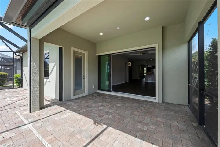 View of patio / terrace featuring a lanai