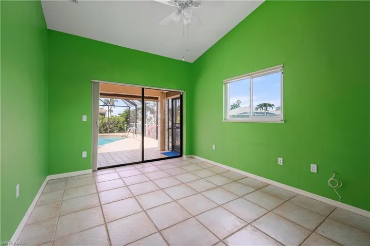Tile floors, doors to and view of pool, view of canal through window