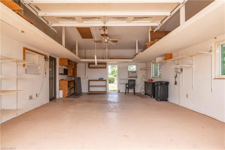 Third bay of garage with storage and A/C wall unit