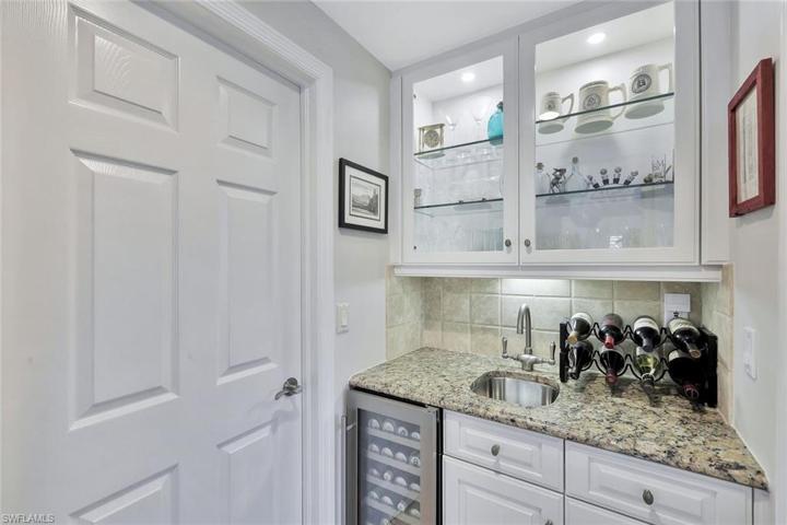 Wine cooler, sink, and beautiful cabinetry where you can showcase your finest glassware.