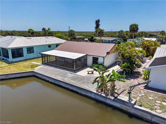 Home at beginning of widened canal with plenty of room to add dock and/or pool.