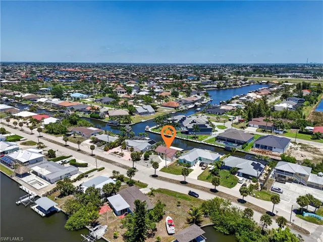 Home overlooks expensive homes in Cape Coral including one worth over $2M.