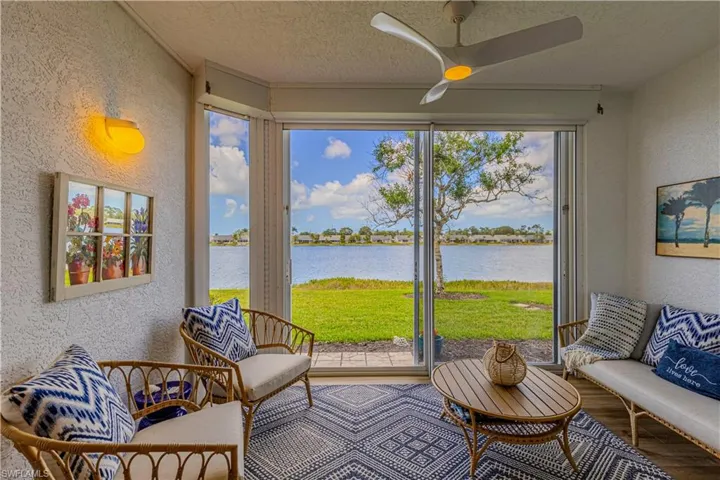 Sunroom featuring a water view