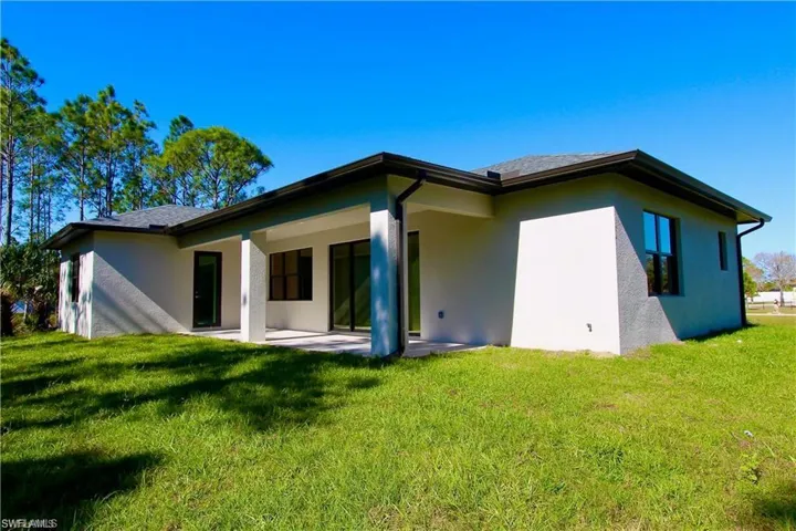 Back of property featuring a patio area and a yard